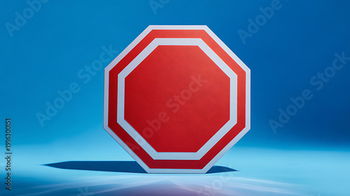Red octagonal road sign with white border on blue background