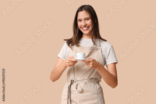 Happy young female barista ...