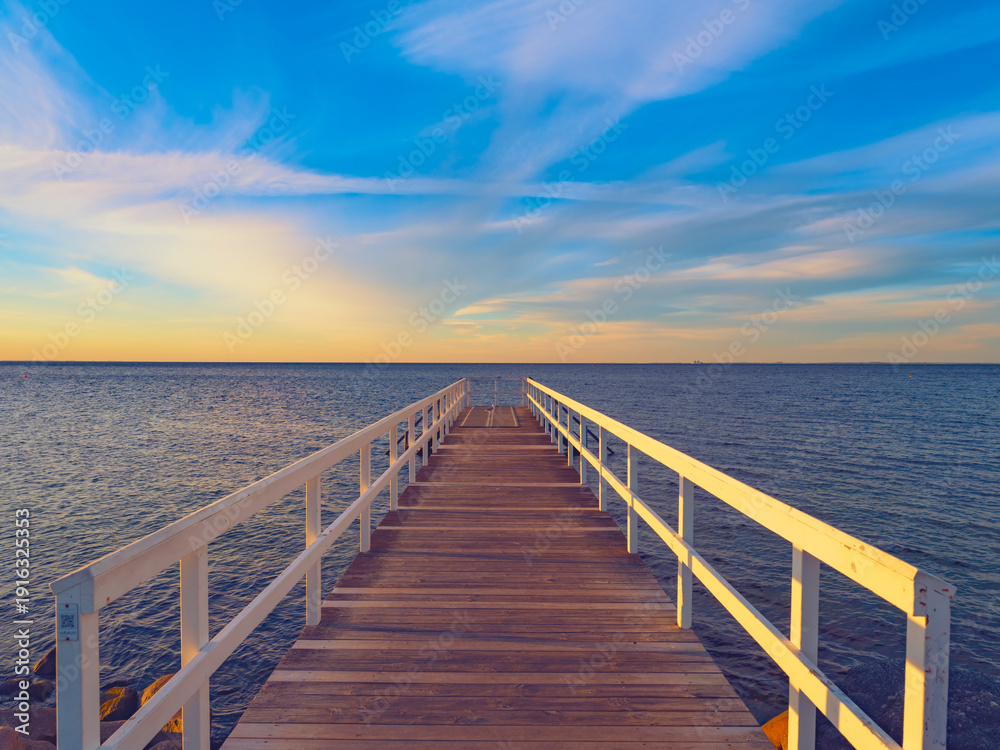 Fototapeta premium wooden bridge over the sea at sunset time