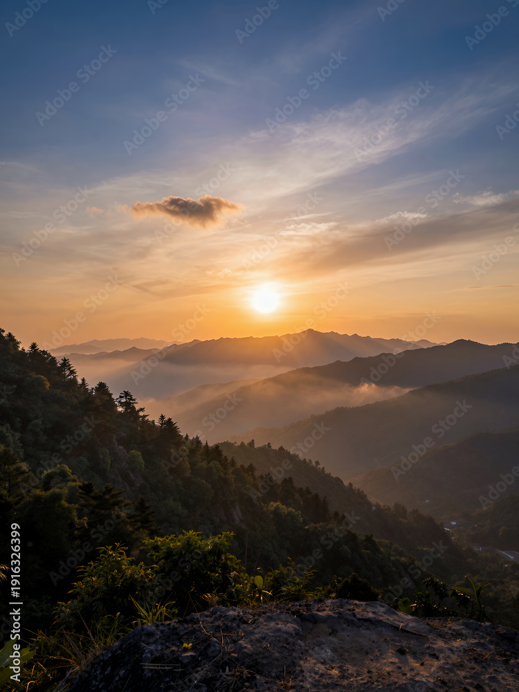 Obraz premium Sunrise Over Misty Mountains With Layered Ridges And A Golden Sky, Serene Nature Landscape