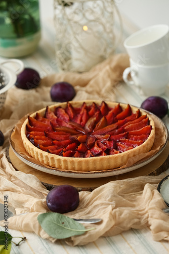 Wallpaper Mural Plate with tasty plum pie, cups and fresh fruits on table in kitchen Torontodigital.ca