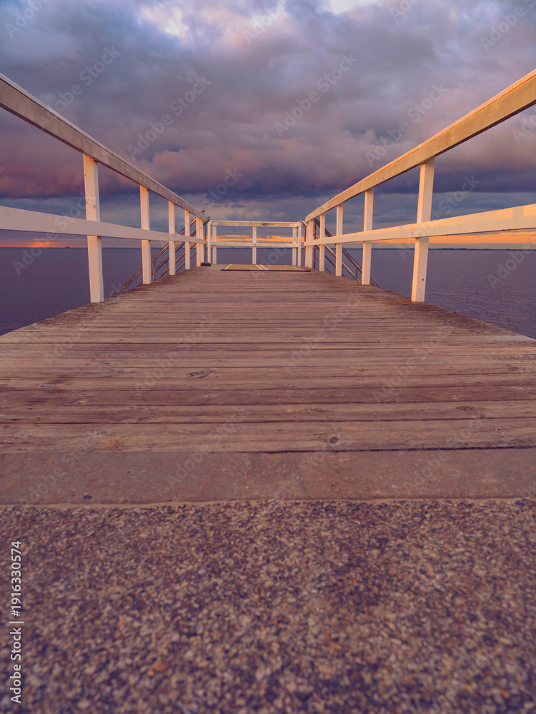 Fototapeta premium wooden pier on the sea at sunset