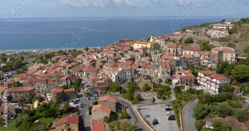 Aerial view of a historic Italian village and its seafront on the horizon. Panorama of Scalea, a town in the province of Cosenza, in Calabria, Southern Italy. It's perched overlooking the sea.