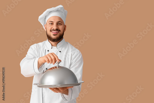 Male chef with cloche on be...