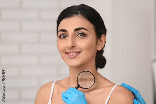 Dermatologist with magnifyi...