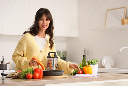 Young woman with recipe boo...