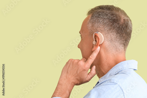 Mature man with hearing aid...