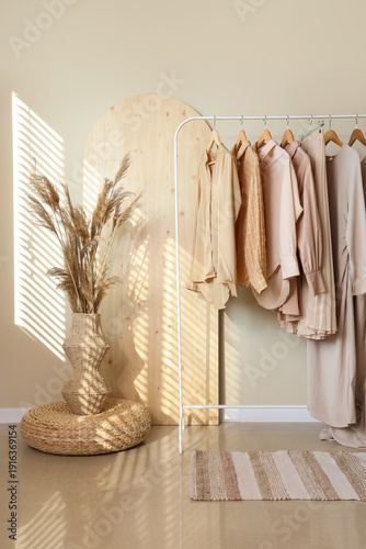 Clothes rack and vase with ...