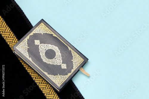 Koran and prayer rug on blu...