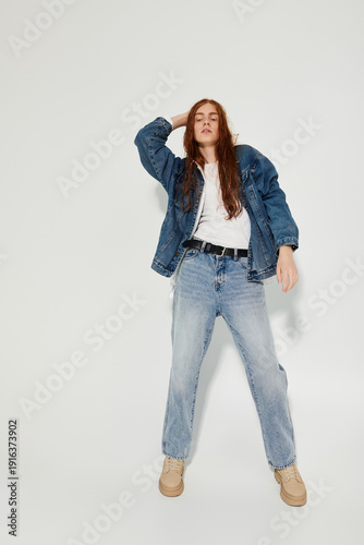 Φωτογραφία Redhead young man exudes confidence in stylish denim attire within modern grey s