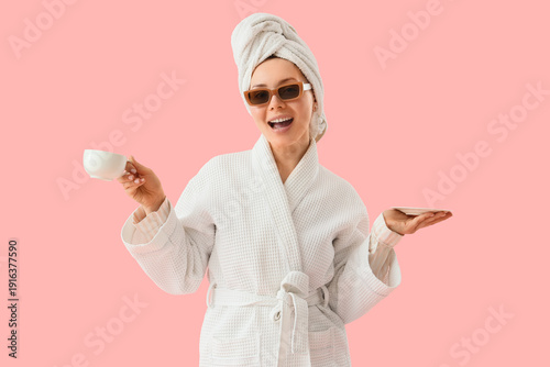 Young woman in robe and sun...