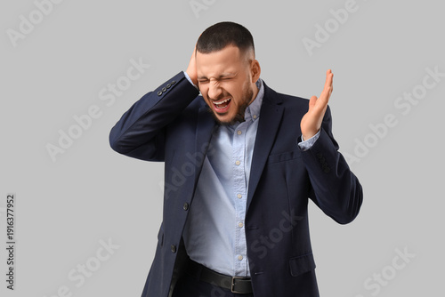 Young businessman suffering...