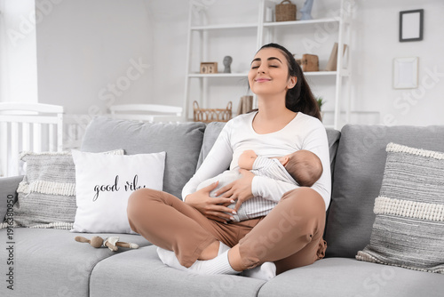 Young woman breastfeeding h...