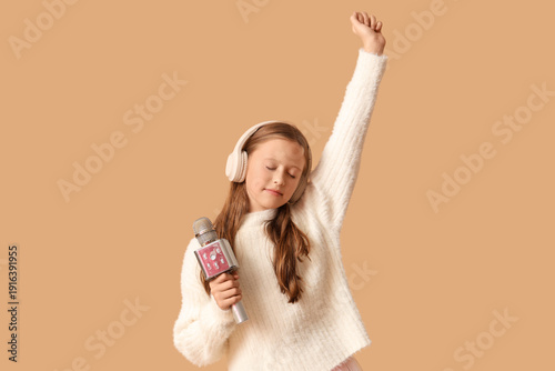 Cute girl in headphones wit...