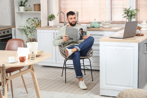 Young bearded man reading m...