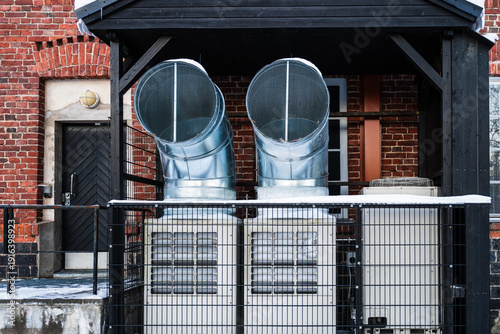 Принти на полотні Industrial ventilation system with air ducts and heat pumps on brick building ex