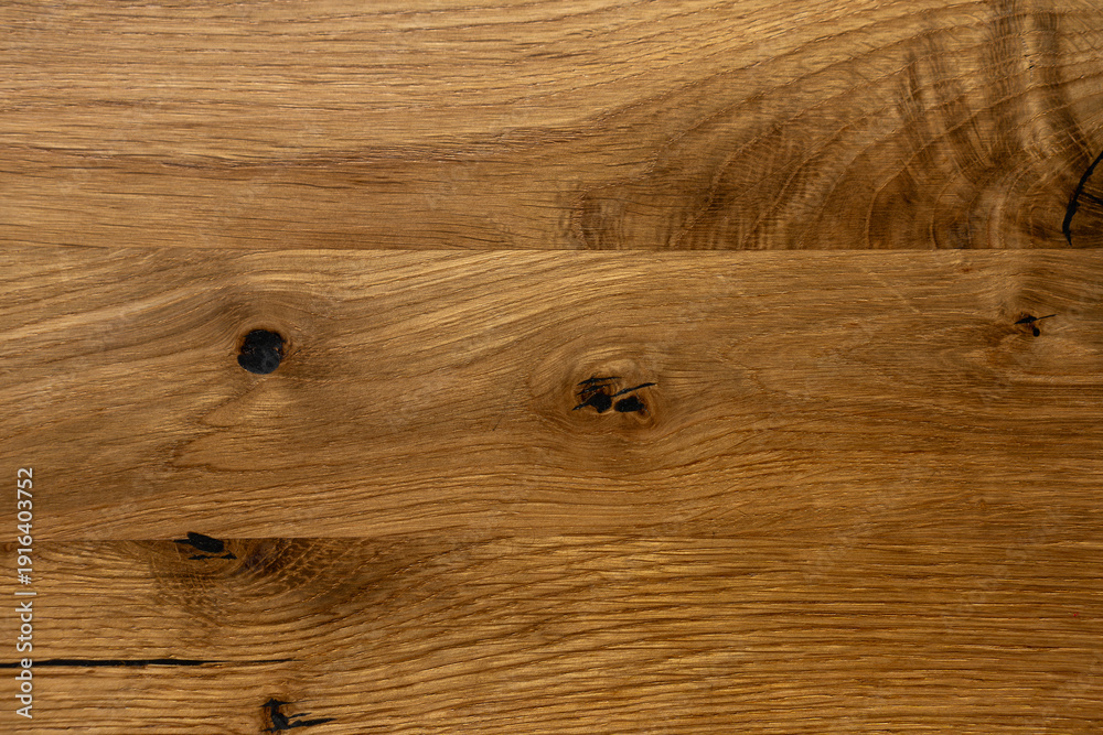 Fototapeta premium Close-up texture of natural oak wood surface with knots and cracks, rustic wooden background.