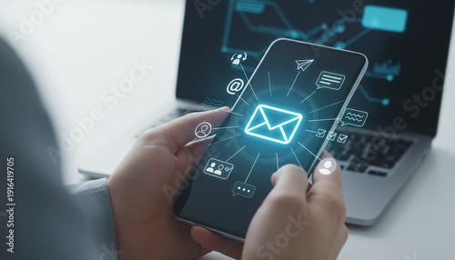 Bild auf Leinwand Smartphone user holding mobile device showing glowing email icon and digital com