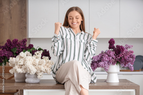 Young happy woman sitting o...