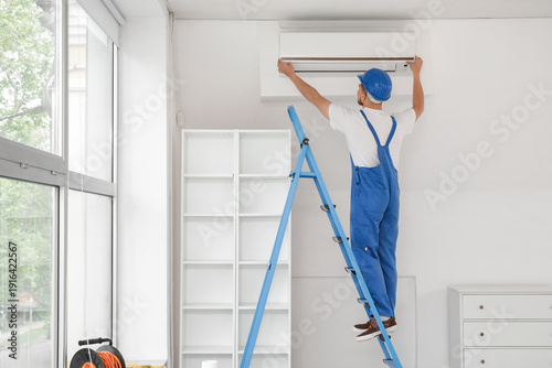 Male contractor on stepladd...