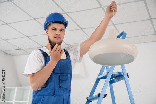 Male contractor talking on ...