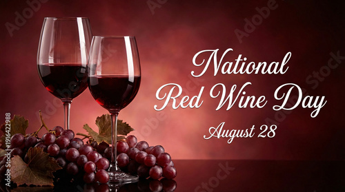 Two elegant wine glasses filled with red wine and a cluster of red grapes, celebrating 
