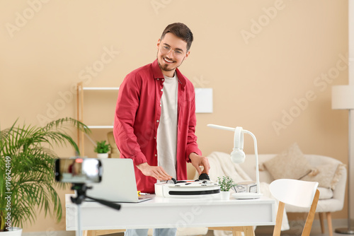 Young male blogger recordin...