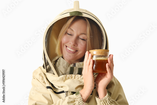 Female beekeeper with jar o...