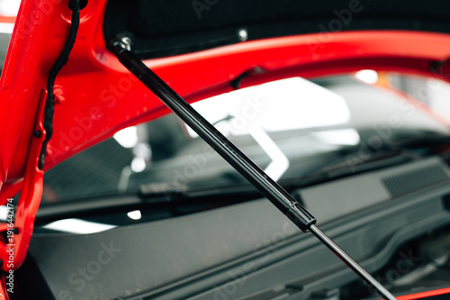 Cuadro en lienzo Gas bonnet strut of a new red vehicle