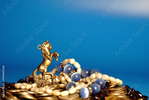 Wallpaper Mural Metal statuette of a horse and jewelry. Finance and luxury. Torontodigital.ca
