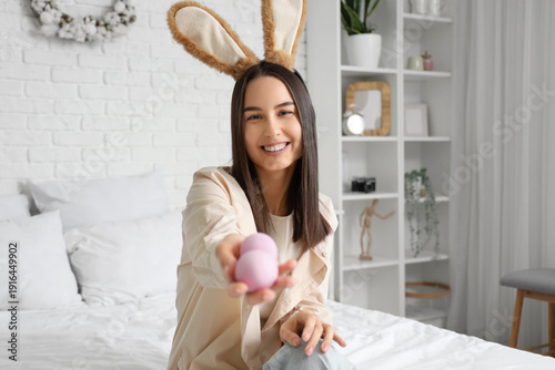 Young woman with bunny ears...