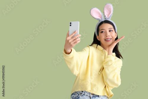 Young Asian woman in bunny ...