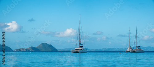 Cane Garden Bay beach on  Tortola's north shore, renowned for its white sand, calm turquoise waters, and vibrant beach bar scene, British Virgin Islands