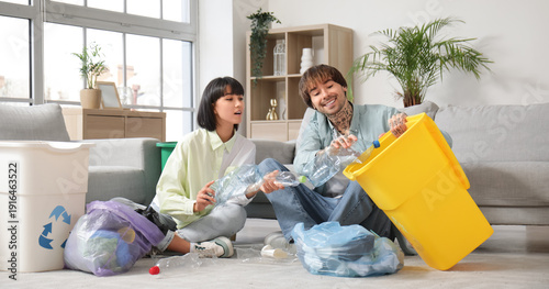 Young couple with garbage c...