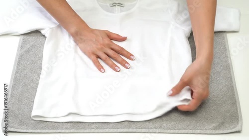 Video of Close-Up of Woman’s Hands Straightening White T-Shirt – Fabric Demonstration