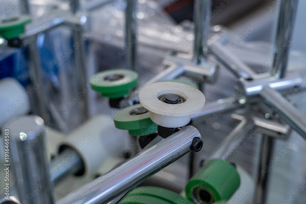 Fototapeta premium Industrial machine detail with rollers and metal elements