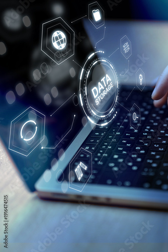 Focus on laptop and data storage symbols during work session at night