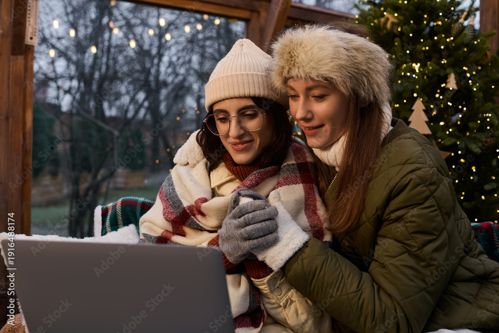Fototapeta premium Loving couple warms up together while enjoying cozy winter moments indoors