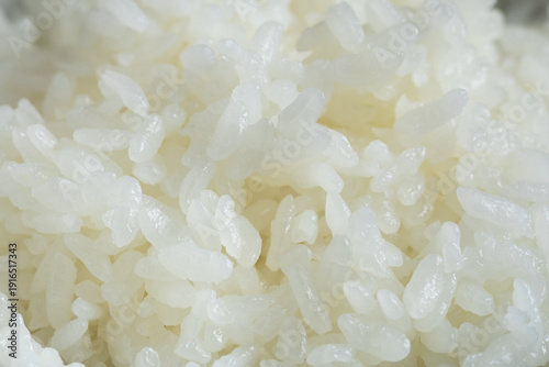 Photography Close-up of freshly cooked Japanese rice with soft, fluffy texture and glossy grains, suitable for food background, Asian cuisine, restaurant menus, and commercial use