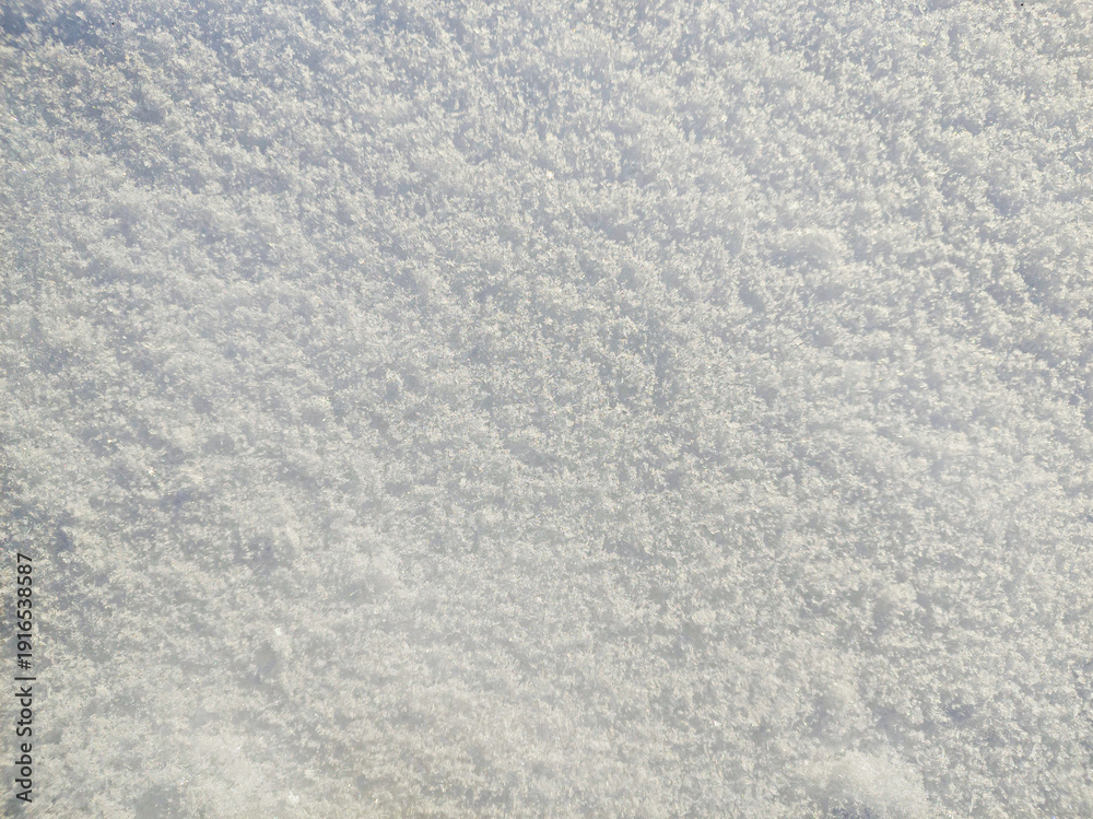 Fototapeta premium Close up of real fresh white snow surface with shimmering flakes. Winter nature abstract background