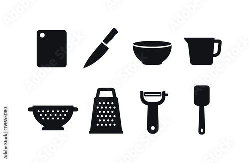 Kitchen food prep utensils: cutting board, chef knife, mixing bowl, measuring cup, colander, grater, peeler, spatula