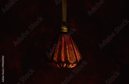 Red Christmas ornament with black background.