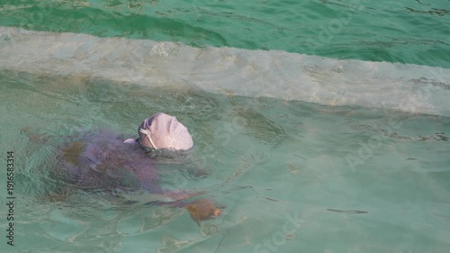 slow motion of preschool child girl learning to diving in swimming pool