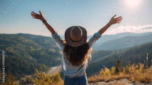Back view of a happy woman enjoying freedom with open hands on beautiful mountain view. Enjoy life, Travel concept