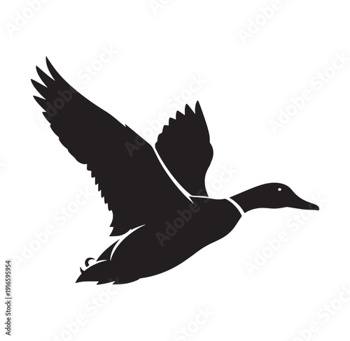 black silhouette of a duck in flight with wings spread wide flying