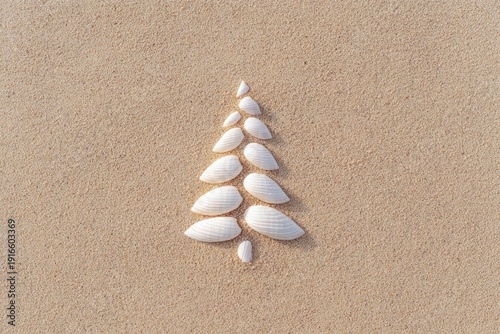 Unique arrangement of seashells forming tree shape on sandy surf