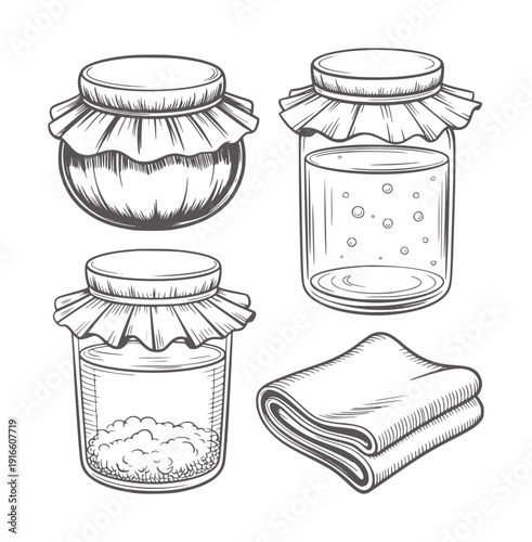 Black and white of four jars with lids and a folded cloth glass
