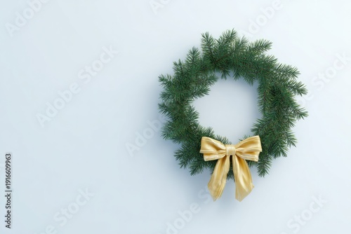 Circular wreath adorned with lush greenery and delicate gold bow