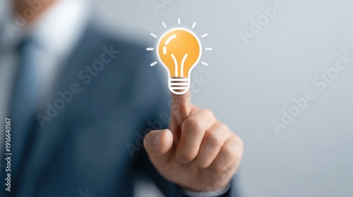 Businessman Touching Light Bulb Symbolizing New Ideas and Bright Solutions in Professional Setting