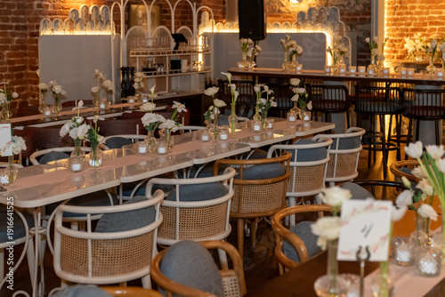 Close up view of wedding table setting with flowers and candles in a warm scene.